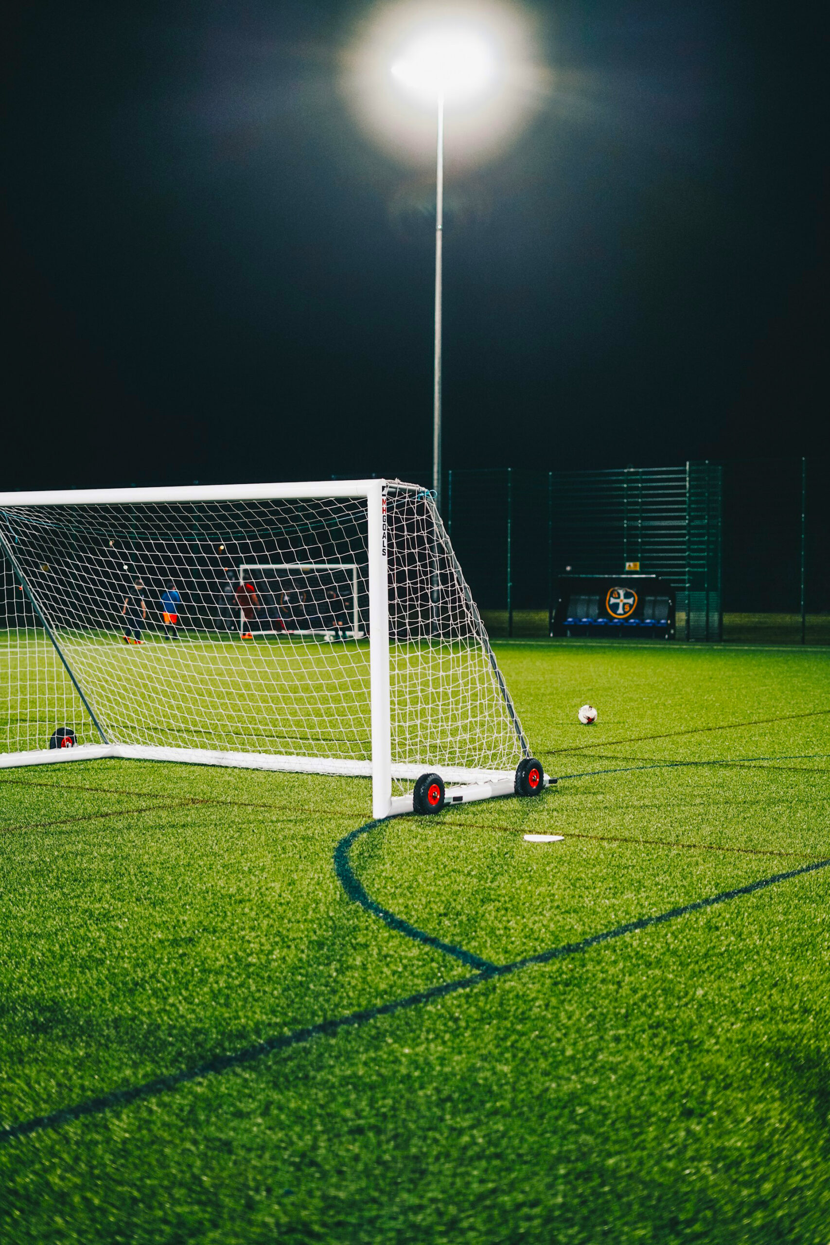 Floodlight and goal during evening team training session.